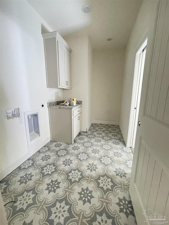 laundry area featuring baseboards, cabinet space, and hookup for an electric dryer