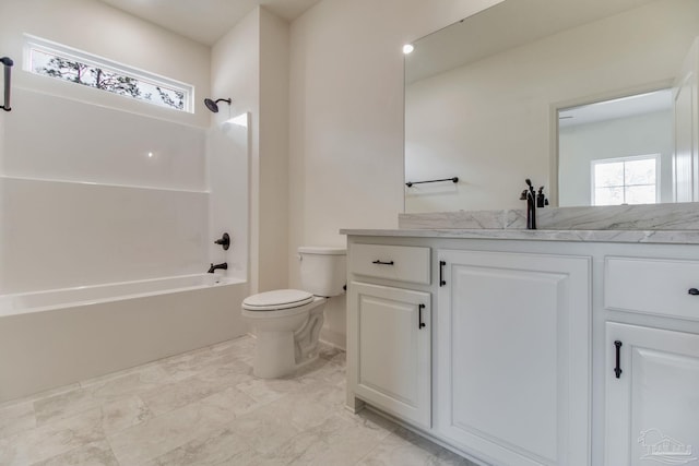 bathroom featuring shower / washtub combination, a wealth of natural light, vanity, and toilet