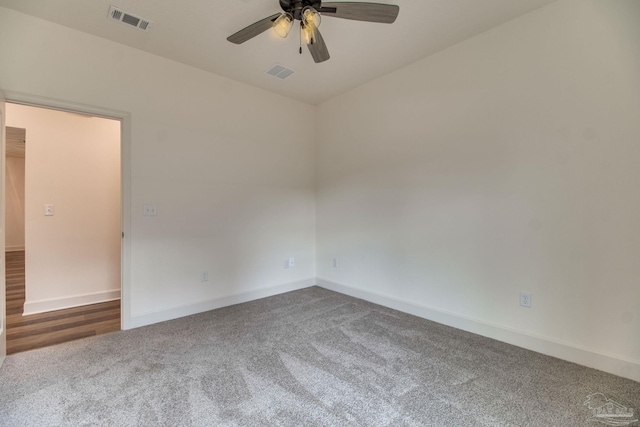 spare room featuring a ceiling fan, visible vents, and baseboards