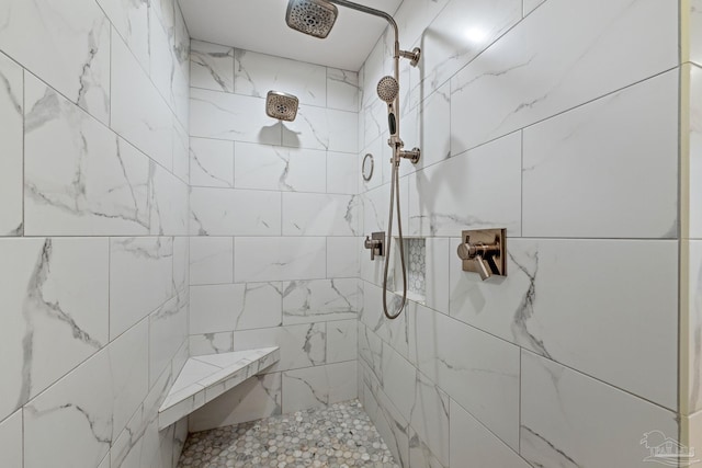 full bathroom with tiled shower