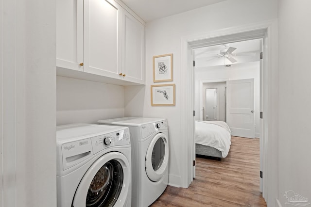 washroom with ceiling fan, separate washer and dryer, light wood-type flooring, and cabinet space