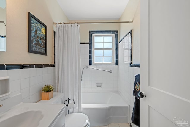 bathroom with toilet, vanity, shower / bath combo with shower curtain, and tile walls