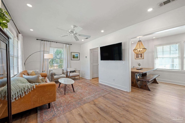 living room featuring ceiling fan, recessed lighting, visible vents, baseboards, and light wood finished floors