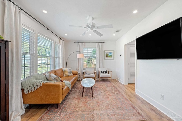 living room featuring recessed lighting, visible vents, baseboards, a ceiling fan, and light wood-type flooring