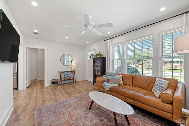 living area with ceiling fan, light wood-type flooring, baseboards, and recessed lighting