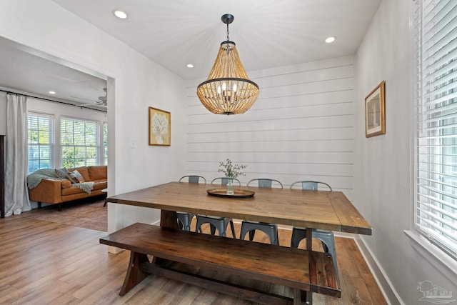 dining space with a chandelier, wood finished floors, and recessed lighting