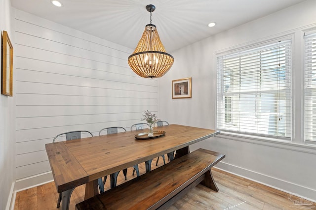 dining room featuring light wood-type flooring, a notable chandelier, baseboards, and recessed lighting