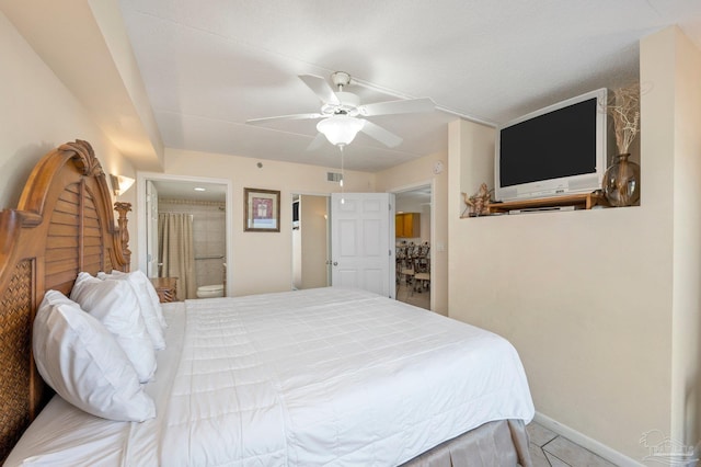 bedroom with visible vents, ensuite bathroom, a ceiling fan, tile patterned flooring, and baseboards