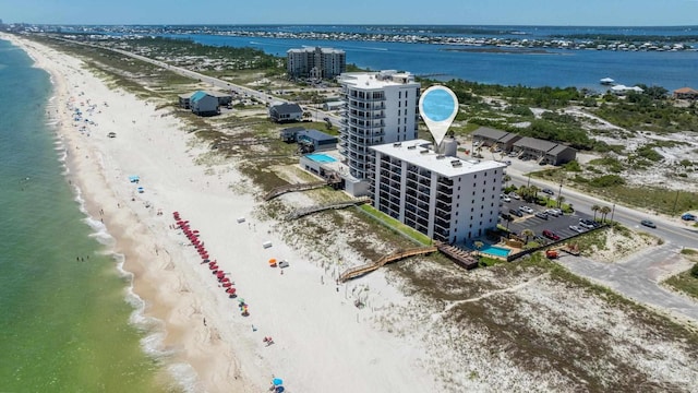 drone / aerial view featuring a water view and a beach view