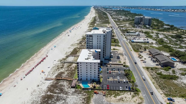 drone / aerial view featuring a water view and a beach view