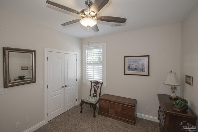 sitting room with carpet, visible vents, baseboards, and ceiling fan