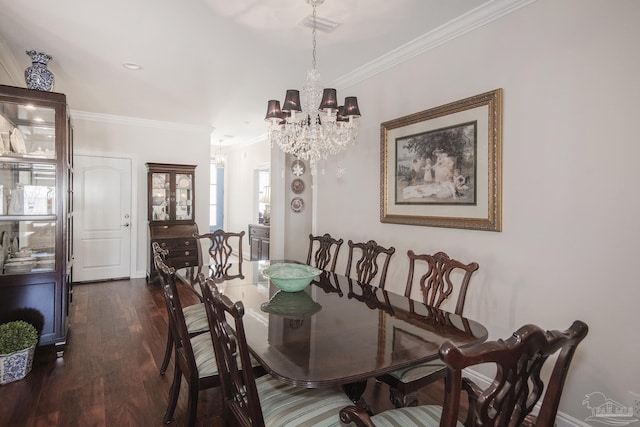 dining room featuring dark wood finished floors, a notable chandelier, and crown molding