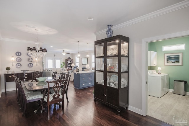 dining area with dark wood-style floors, crown molding, baseboards, and separate washer and dryer