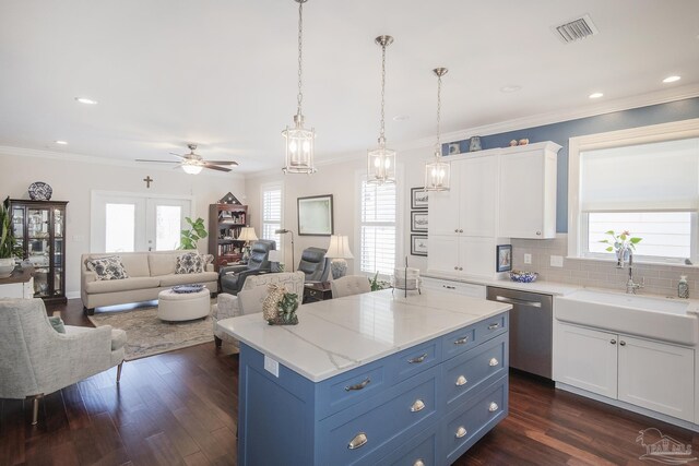 kitchen with pendant lighting, blue cabinetry, visible vents, white cabinets, and dishwasher