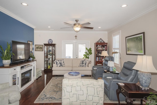 living area featuring crown molding, dark wood-type flooring, and a healthy amount of sunlight