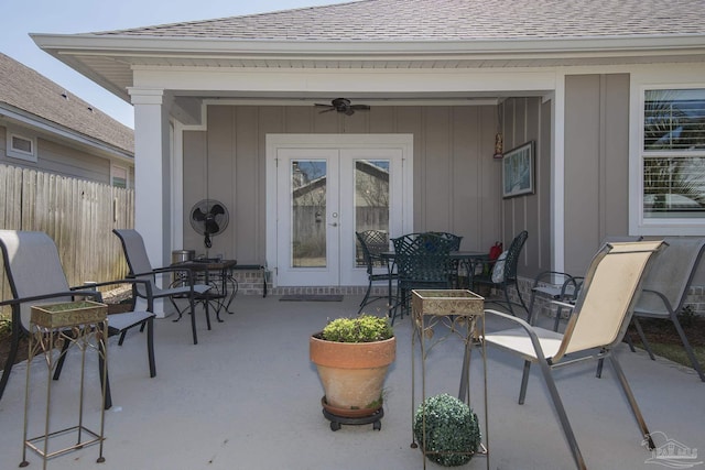 view of patio featuring fence, outdoor dining area, a ceiling fan, and french doors