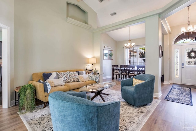 9348 Bell Ridge Dr, Pensacola, FL 32526 - living room with baseboards, high vaulted ceiling, a notable chandelier, and wood finished floors