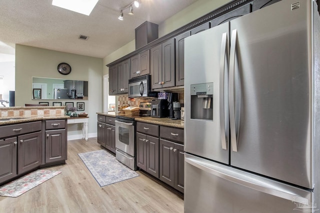9348 Bell Ridge Dr, Pensacola, FL 32526 - kitchen featuring stainless steel appliances, light stone countertops, visible vents, and light wood-type flooring