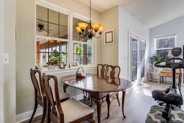 9348 Bell Ridge Dr, Pensacola, FL 32526 - dining room featuring an inviting chandelier, wood finished floors, and lofted ceiling