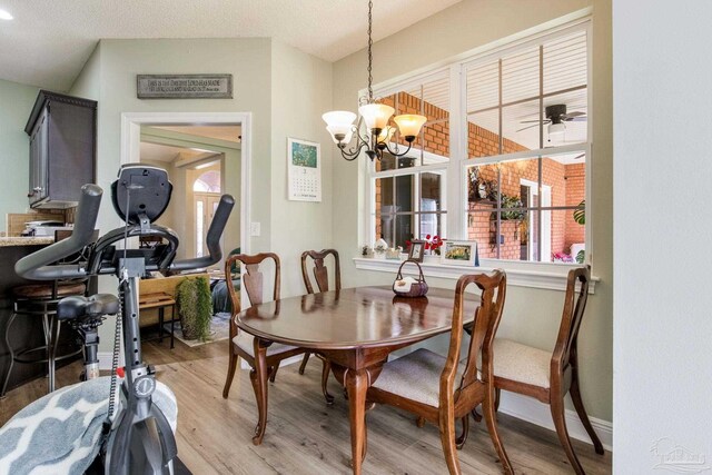 9348 Bell Ridge Dr, Pensacola, FL 32526 - dining area featuring a chandelier and light wood-type flooring