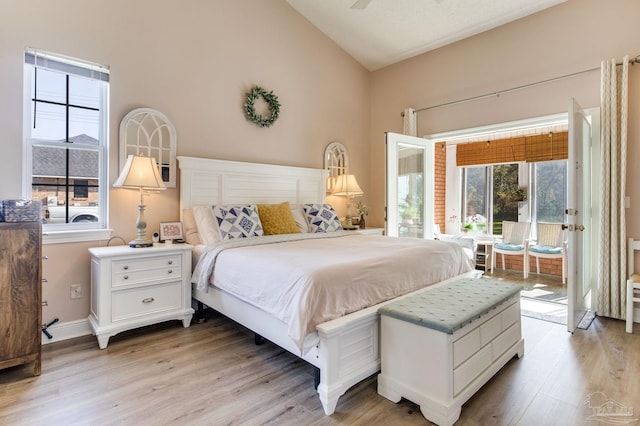 9348 Bell Ridge Dr, Pensacola, FL 32526 - bedroom featuring baseboards, vaulted ceiling, light wood-style flooring, and access to exterior