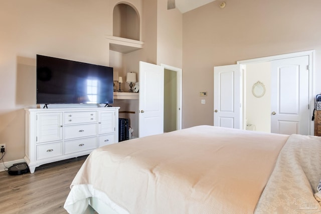 9348 Bell Ridge Dr, Pensacola, FL 32526 - bedroom with baseboards, wood finished floors, and high vaulted ceiling