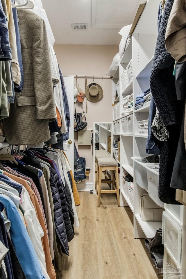 9348 Bell Ridge Dr, Pensacola, FL 32526 - walk in closet featuring visible vents and wood finished floors