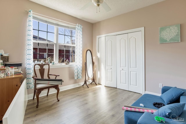 9348 Bell Ridge Dr, Pensacola, FL 32526 - sitting room featuring a textured ceiling, baseboards, a ceiling fan, and wood finished floors