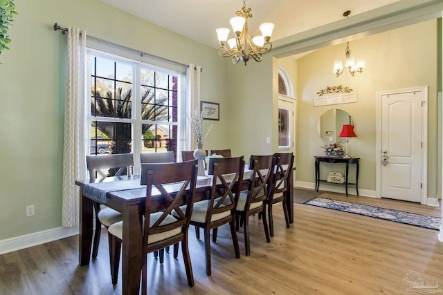 9348 Bell Ridge Dr, Pensacola, FL 32526 - dining area featuring an inviting chandelier, baseboards, and wood finished floors