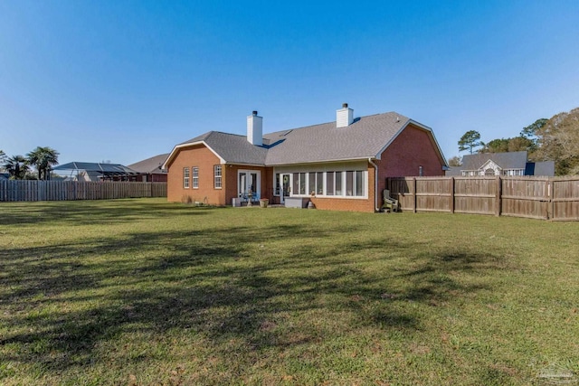 9348 Bell Ridge Dr, Pensacola, FL 32526 - back of property featuring a chimney, french doors, a lawn, brick siding, and a fenced backyard