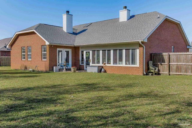 9348 Bell Ridge Dr, Pensacola, FL 32526 - back of house with french doors, fence, a chimney, and brick siding