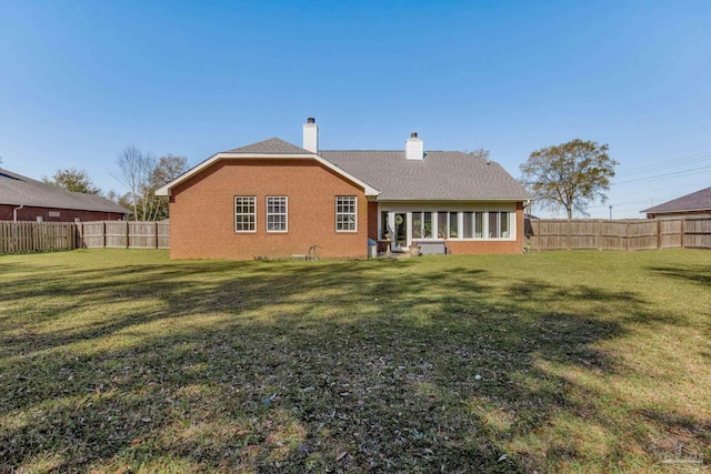9348 Bell Ridge Dr, Pensacola, FL 32526 - back of property featuring a fenced backyard, a chimney, a yard, and brick siding