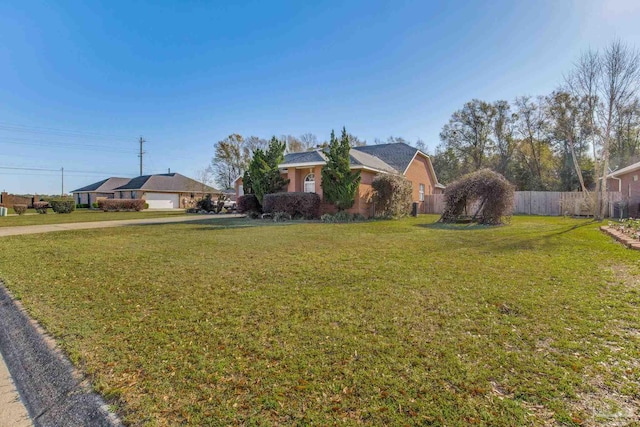 9348 Bell Ridge Dr, Pensacola, FL 32526 - view of yard featuring a garage, fence, and concrete driveway