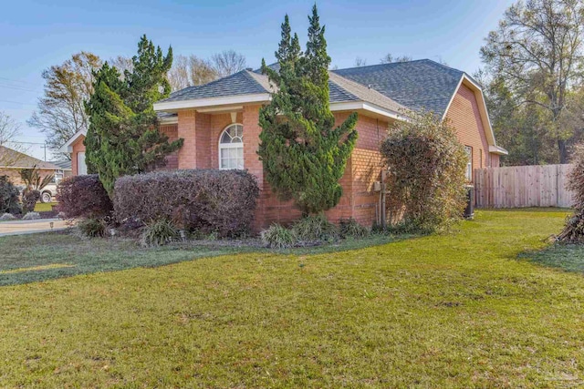 9348 Bell Ridge Dr, Pensacola, FL 32526 - view of property hidden behind natural elements featuring brick siding, roof with shingles, fence, and a front yard