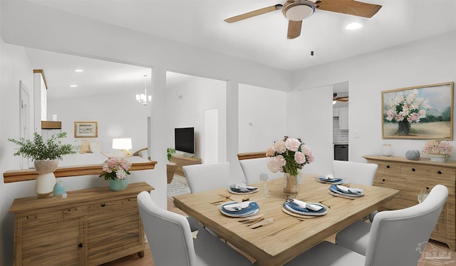 dining space with ceiling fan with notable chandelier