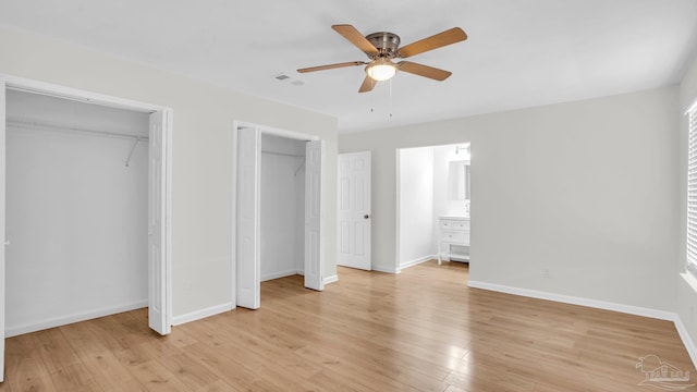 unfurnished bedroom with multiple closets, ceiling fan, and light hardwood / wood-style flooring