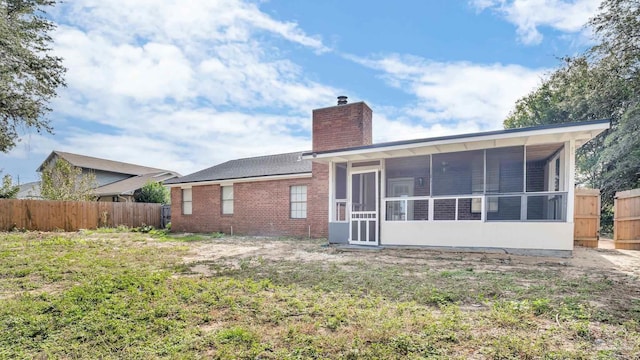 back of property featuring a sunroom