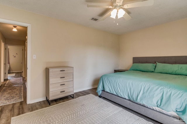 bedroom with ceiling fan and dark wood-type flooring