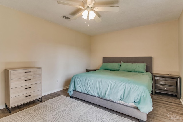 bedroom with ceiling fan and dark wood-type flooring