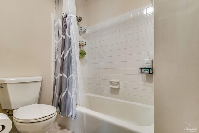 bathroom featuring shower / tub combo and toilet