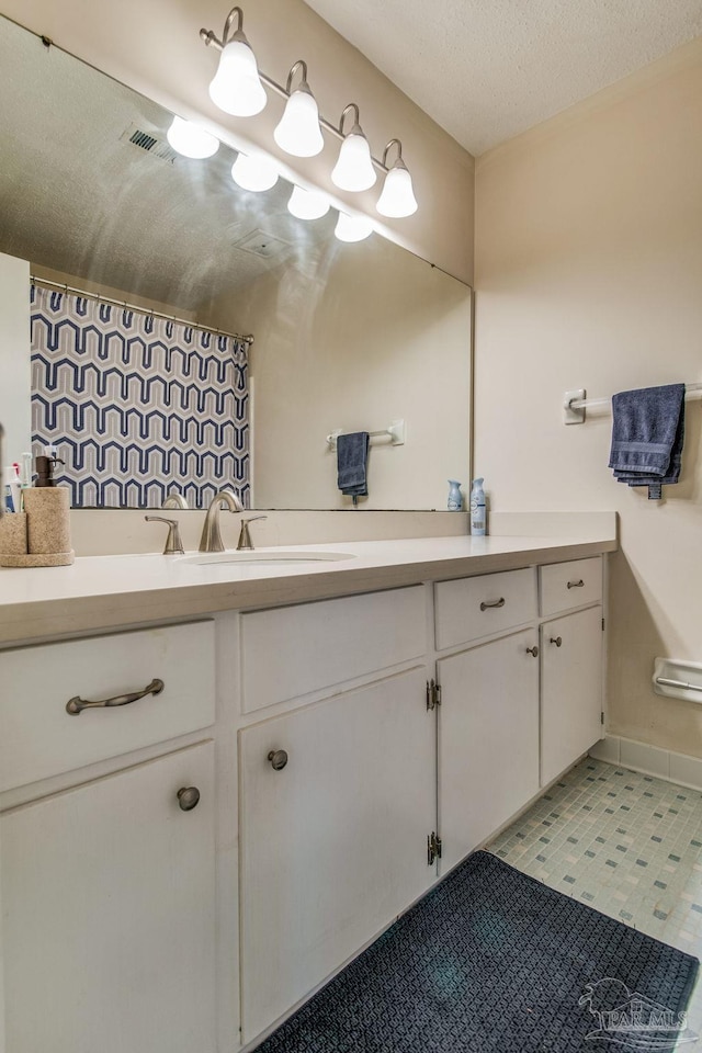 bathroom featuring vanity and a textured ceiling