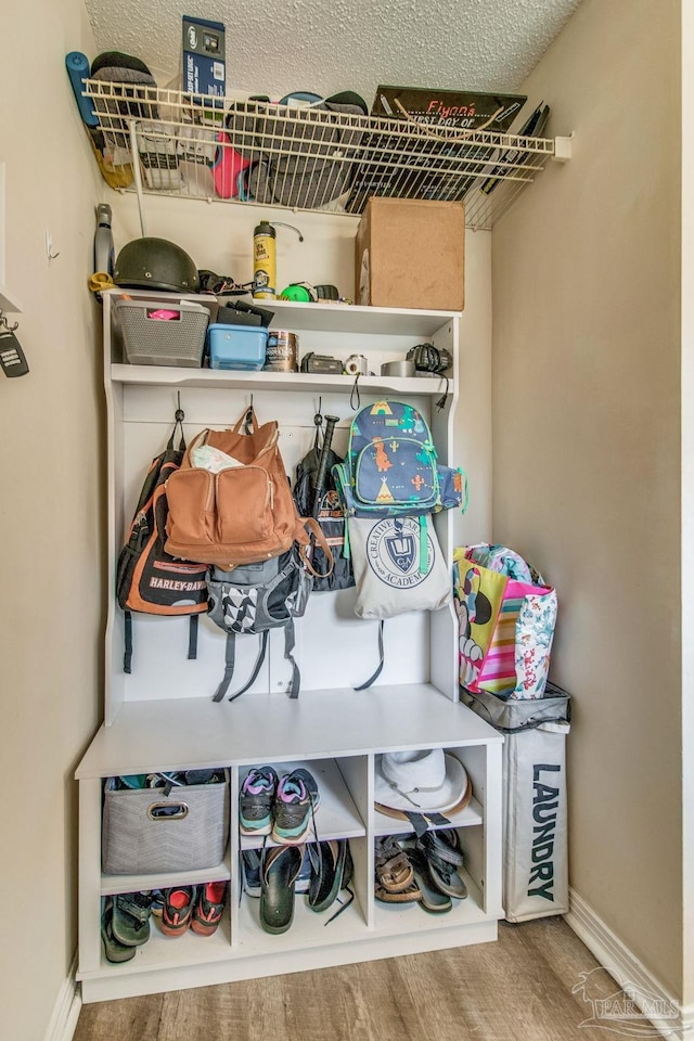 mudroom with hardwood / wood-style flooring and a textured ceiling