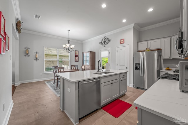 3209 Mountain Laurel Trl, Cantonment, FL 32533 - kitchen with a sink, stainless steel appliances, gray cabinets, a center island with sink, and crown molding