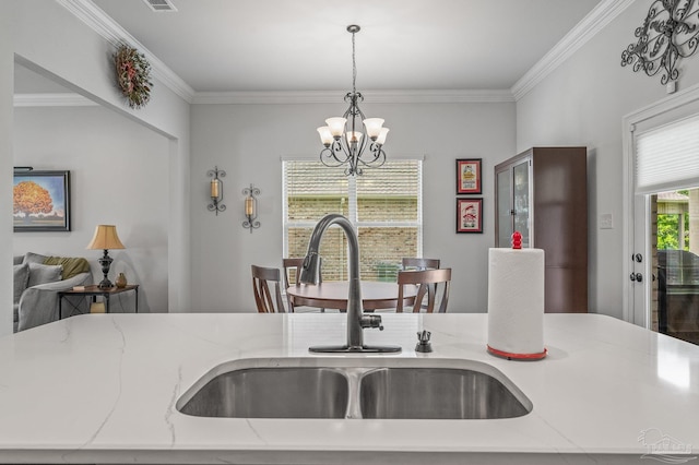 3209 Mountain Laurel Trl, Cantonment, FL 32533 - kitchen with a sink, a chandelier, decorative light fixtures, crown molding, and light stone countertops
