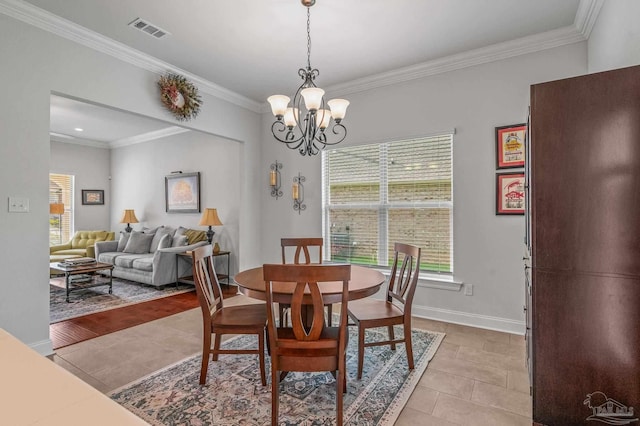 3209 Mountain Laurel Trl, Cantonment, FL 32533 - dining room with plenty of natural light, a chandelier, ornamental molding, light tile patterned flooring, and baseboards