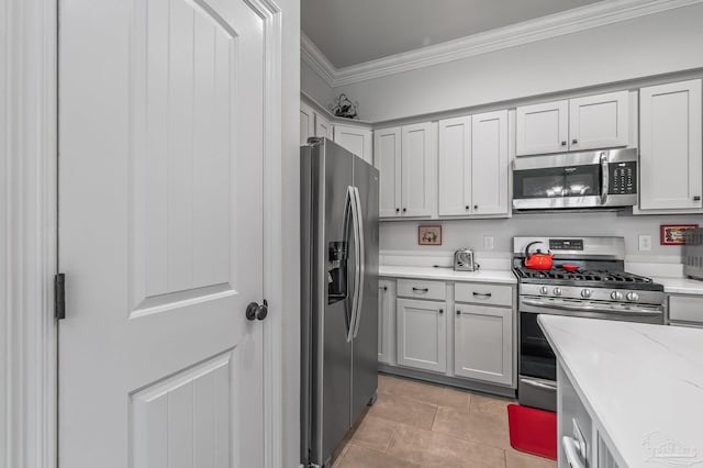 3209 Mountain Laurel Trl, Cantonment, FL 32533 - kitchen featuring appliances with stainless steel finishes, crown molding, light countertops, and light tile patterned flooring