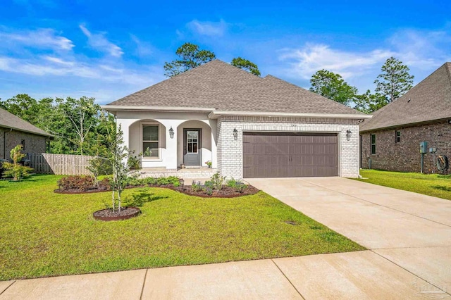 3209 Mountain Laurel Trl, Cantonment, FL 32533 - french provincial home featuring an attached garage, brick siding, a shingled roof, and driveway