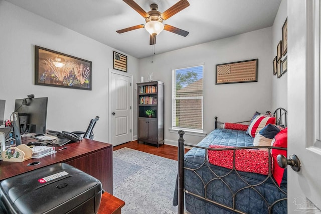 3209 Mountain Laurel Trl, Cantonment, FL 32533 - bedroom featuring an office area, wood finished floors, a ceiling fan, and baseboards