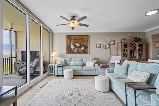 616 Lost Key Dr Unit 902A, Perdido Key, FL 32507 - living room featuring light wood-style floors, ceiling fan, ornamental molding, and a textured ceiling