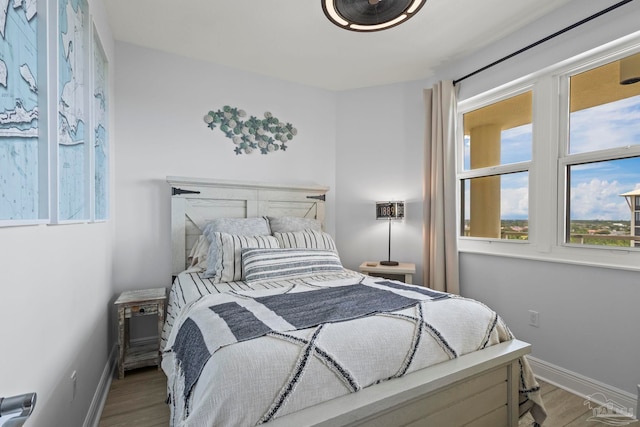 616 Lost Key Dr Unit 902A, Perdido Key, FL 32507 - bedroom featuring wood finished floors and baseboards